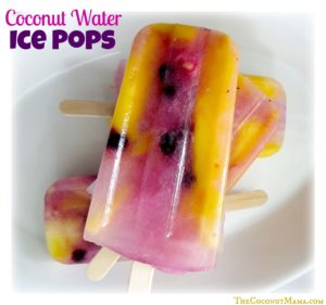 coconut water ice pops with blueberries and mangoes in a white bowl. Text in top left corner reads "Coconut water ice pops"