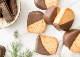 coconut flour cookies dipped in chocolate on a white surface
