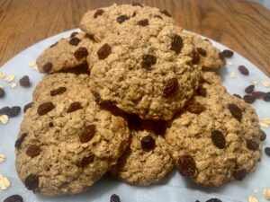 Plate of gluten-free oatmeal raisin cookies on a table.