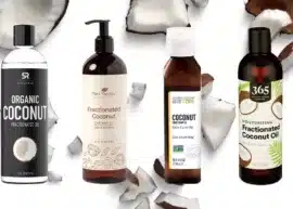 four bottles of fractionated coconut oil superimposed on an image of chunks of coconut meat
