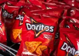 Multiple bags of Doritos Nacho Cheese chips.