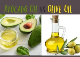Avocado oil in a glass jar placed next to some whole and cut avocados and green leaves. A jar of olive oil placed near a few green olives and leaves.