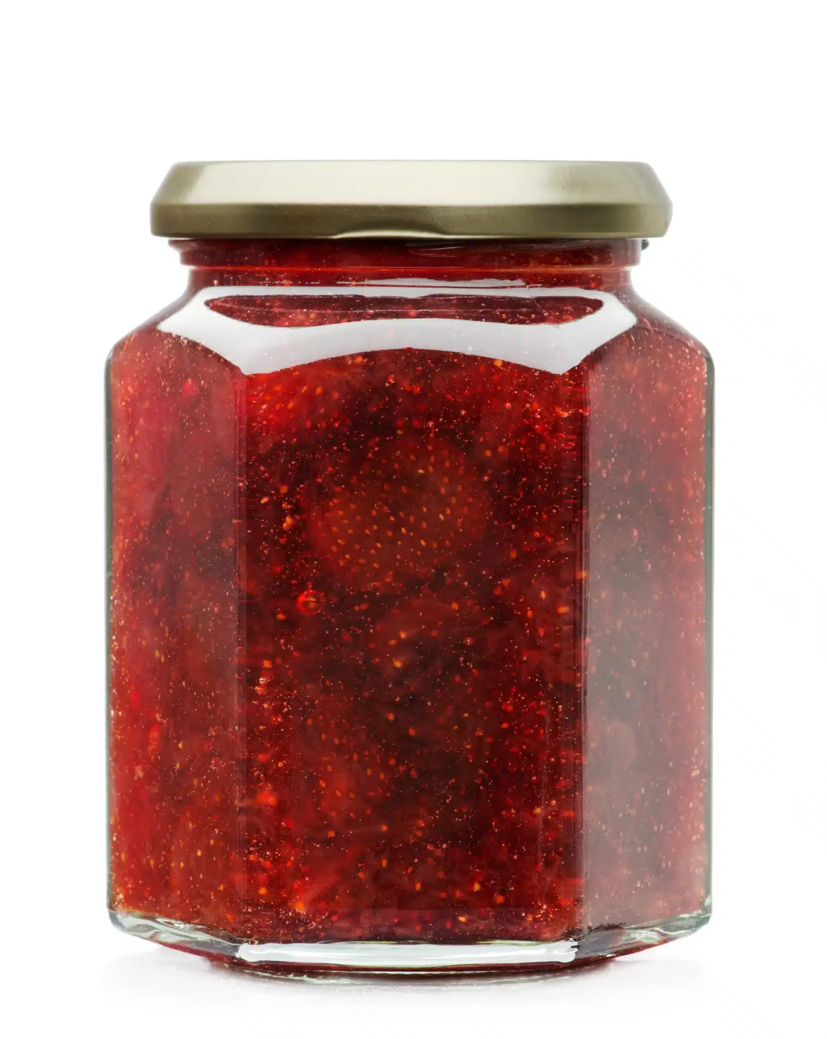 A jar of strawberry jam against a white backdrop.