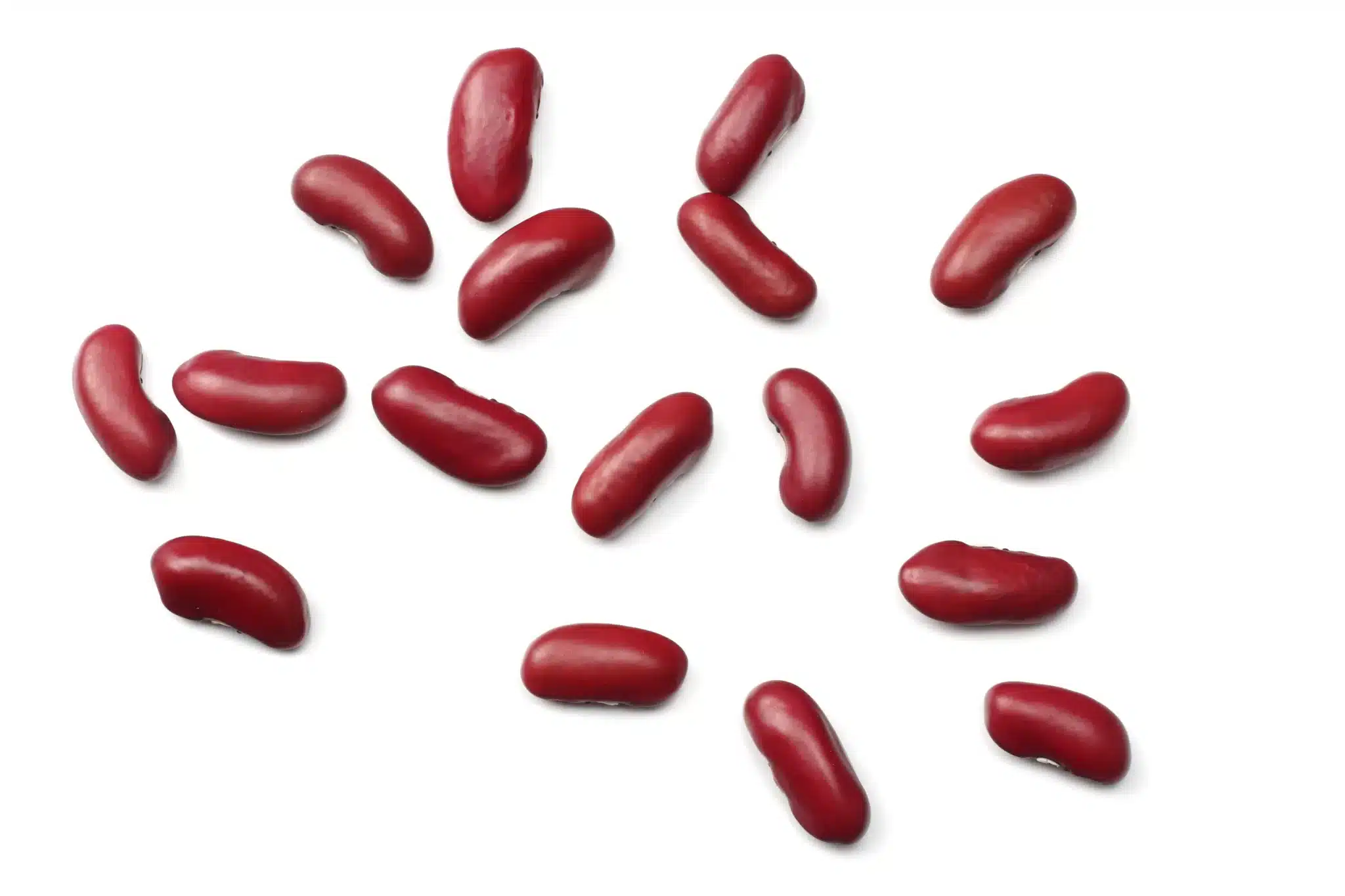 A handful of kidney beans sprinkled on a white surface.