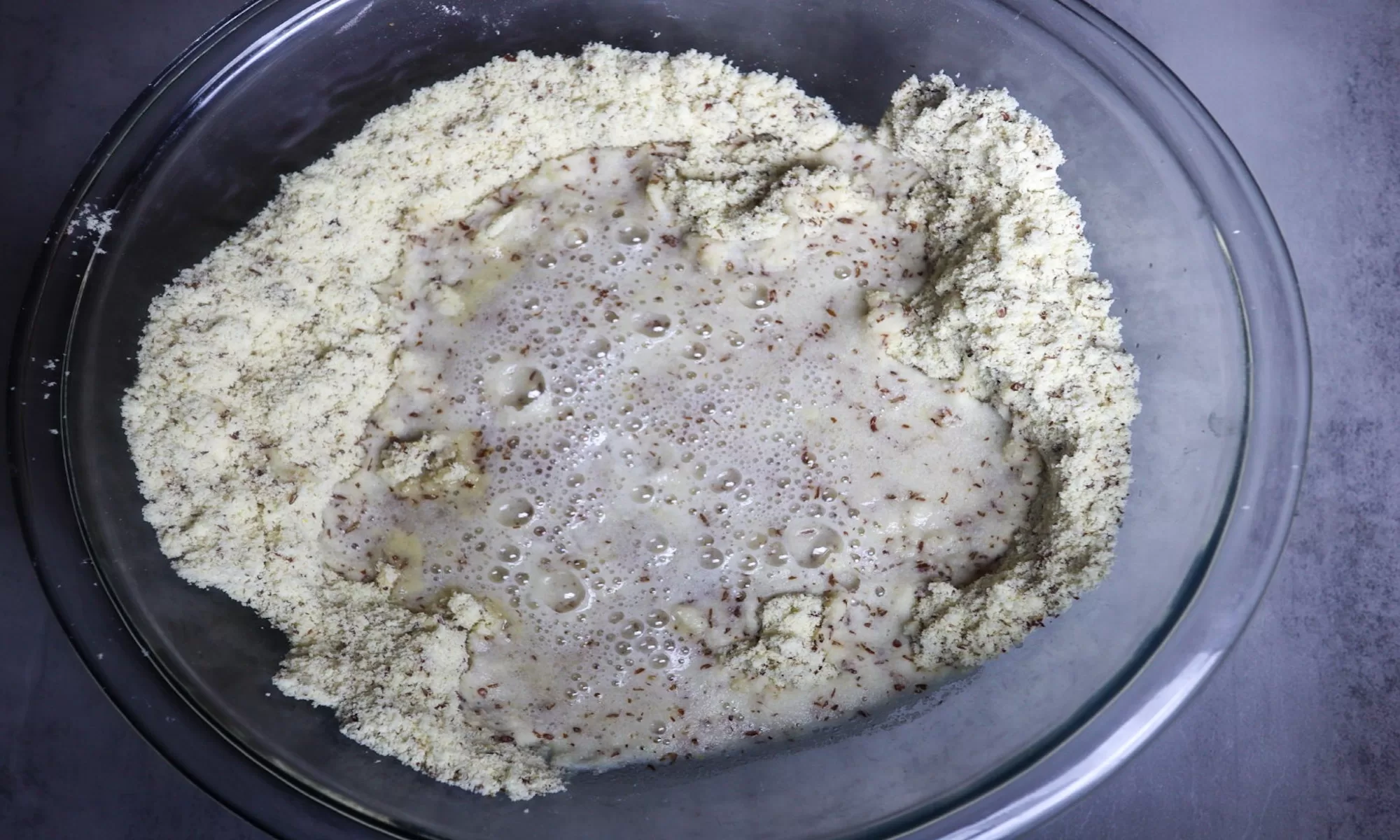 Adding the wet ingredients to the dry ingredients.