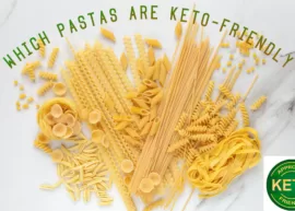 Different types of uncooked pasta scattered on a marble table with a keto-friendly stamp. The text reads, "Which Pastas are Keto-Friendly."