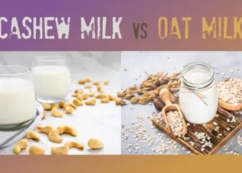 A pair of glasses of cashew milk and a handful of cashews nearby. A jar of oat milk set with a bowl and spoonful of oat flakes, along with some oat ears.