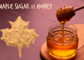 A surface featuring a maple leaf made with maple sugar and a jar of honey.
