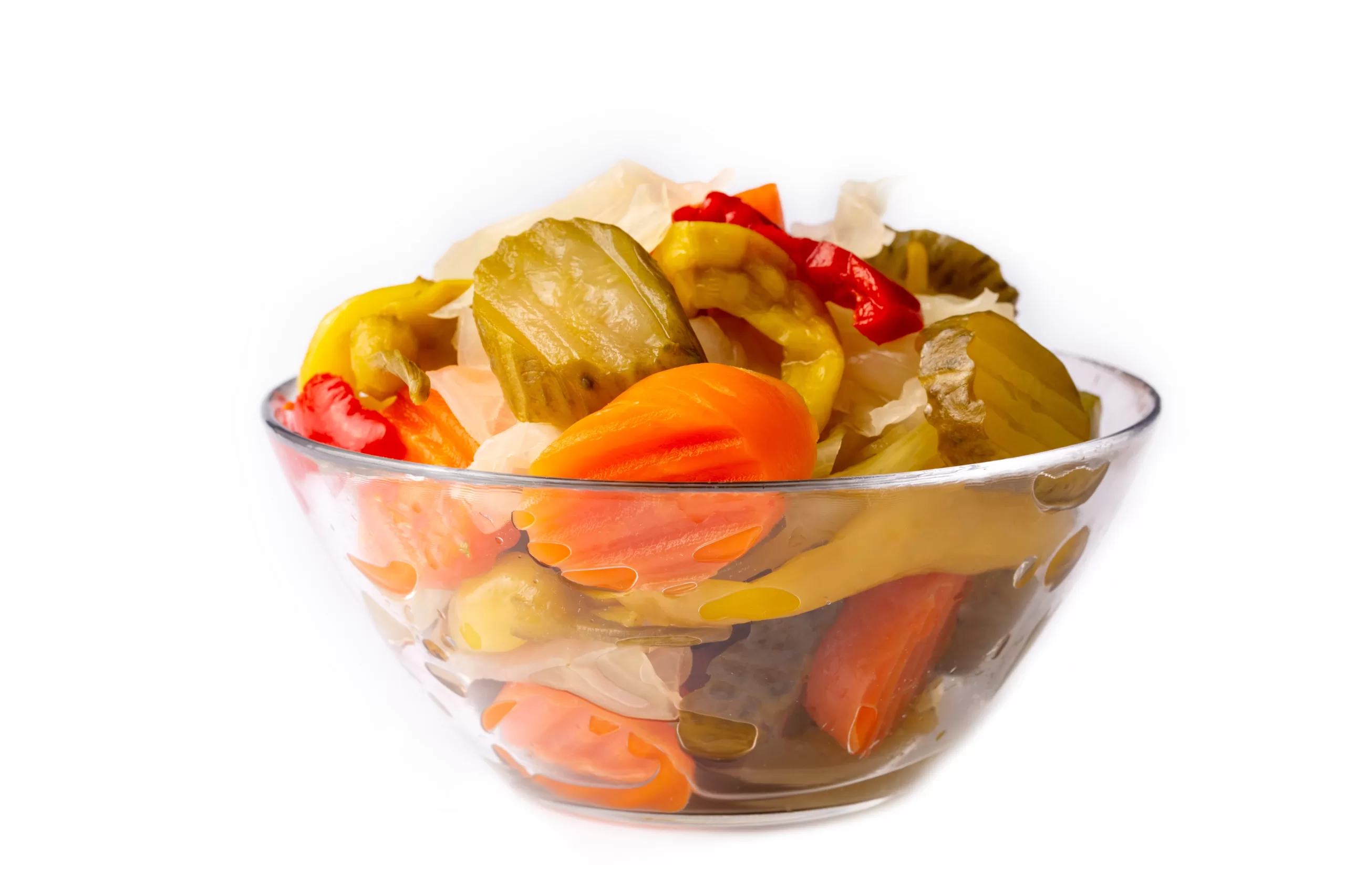 A bowl heaped with pickles on a white plain background.