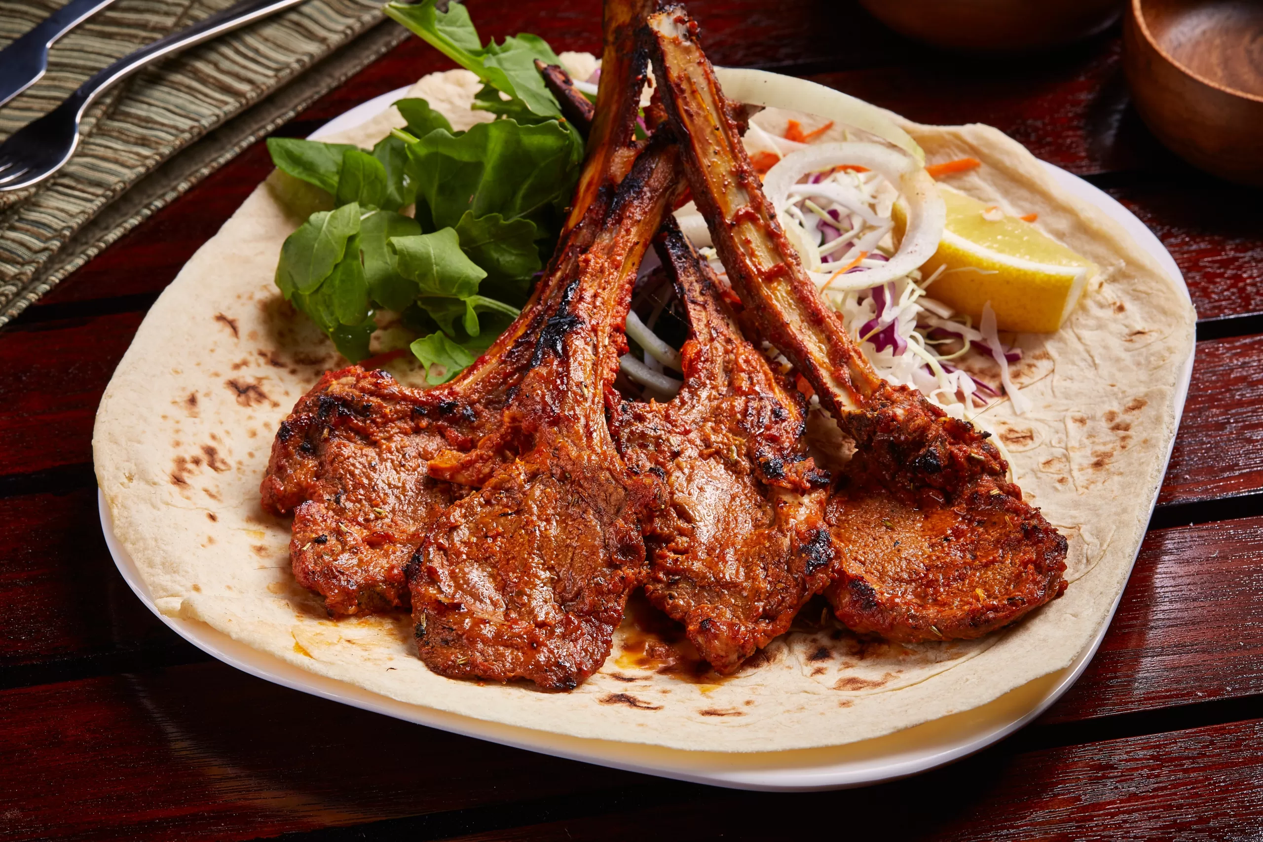   Grilled lamb chops with lemon and salad.