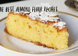 almond flour sponge cake topped with almonds and powdered sugar. Text on top is "the best almond flour recipes".