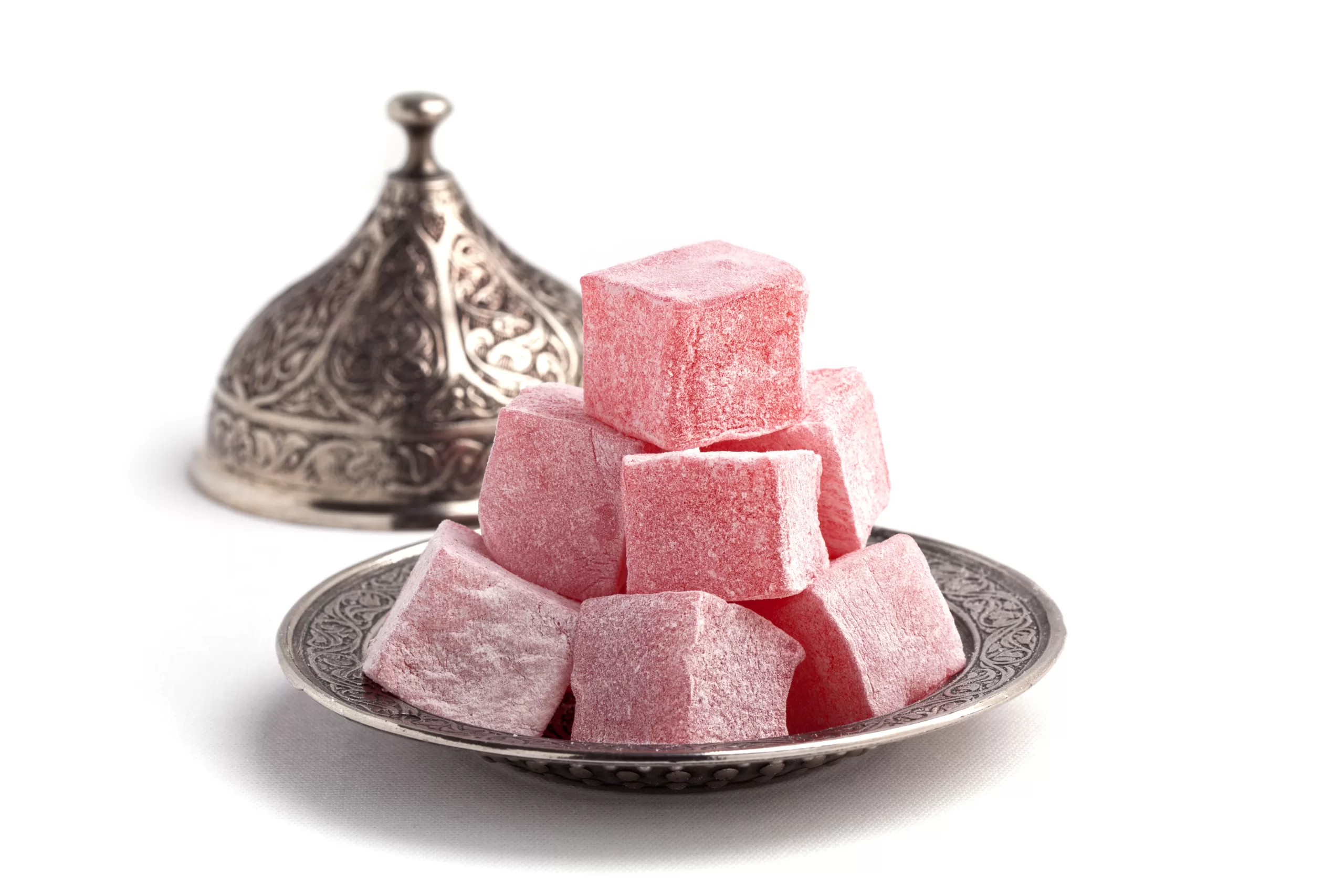 Traditional turkey delight stacked over a plate.