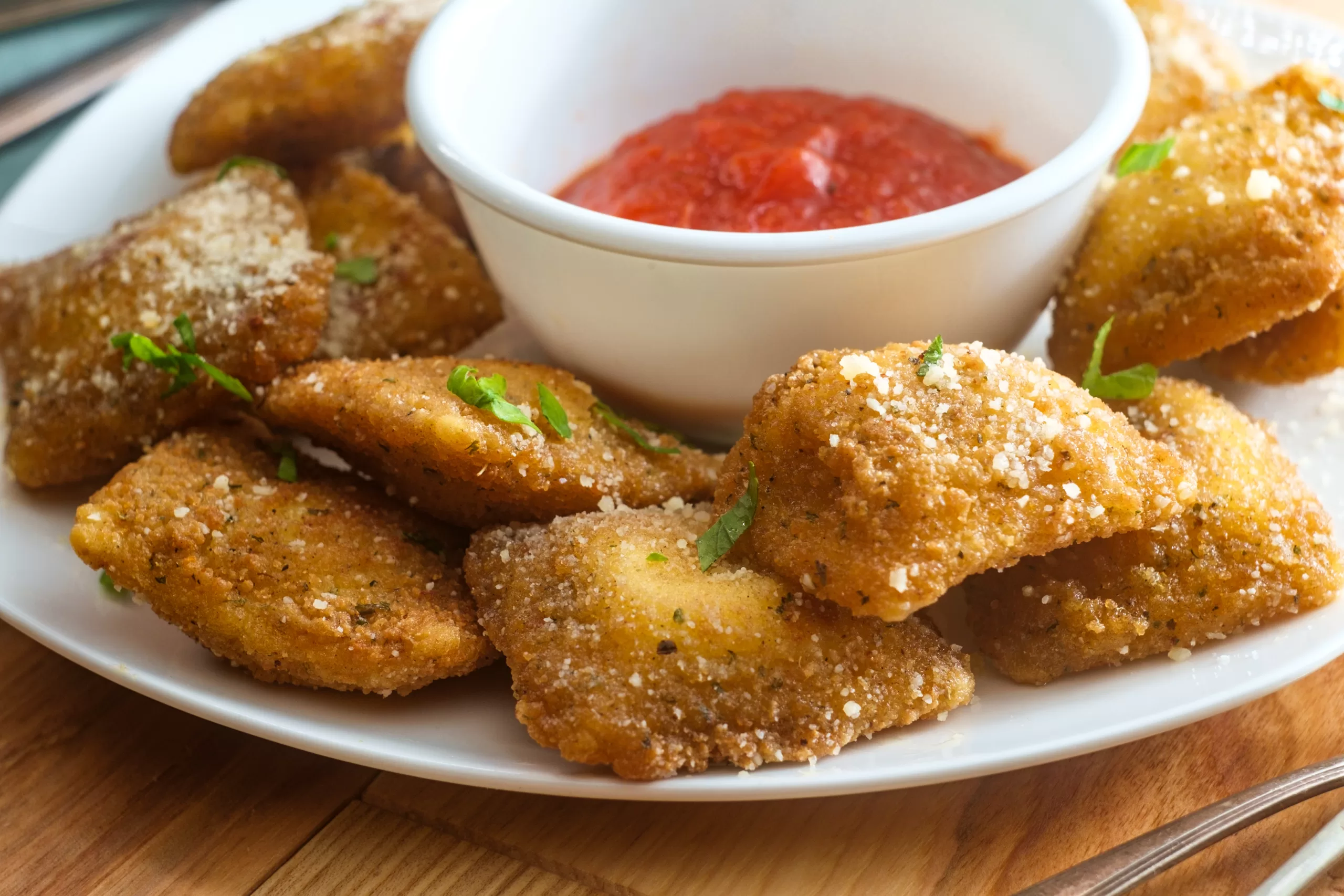 Tempting toasted ravioli served around a tomato dip. 