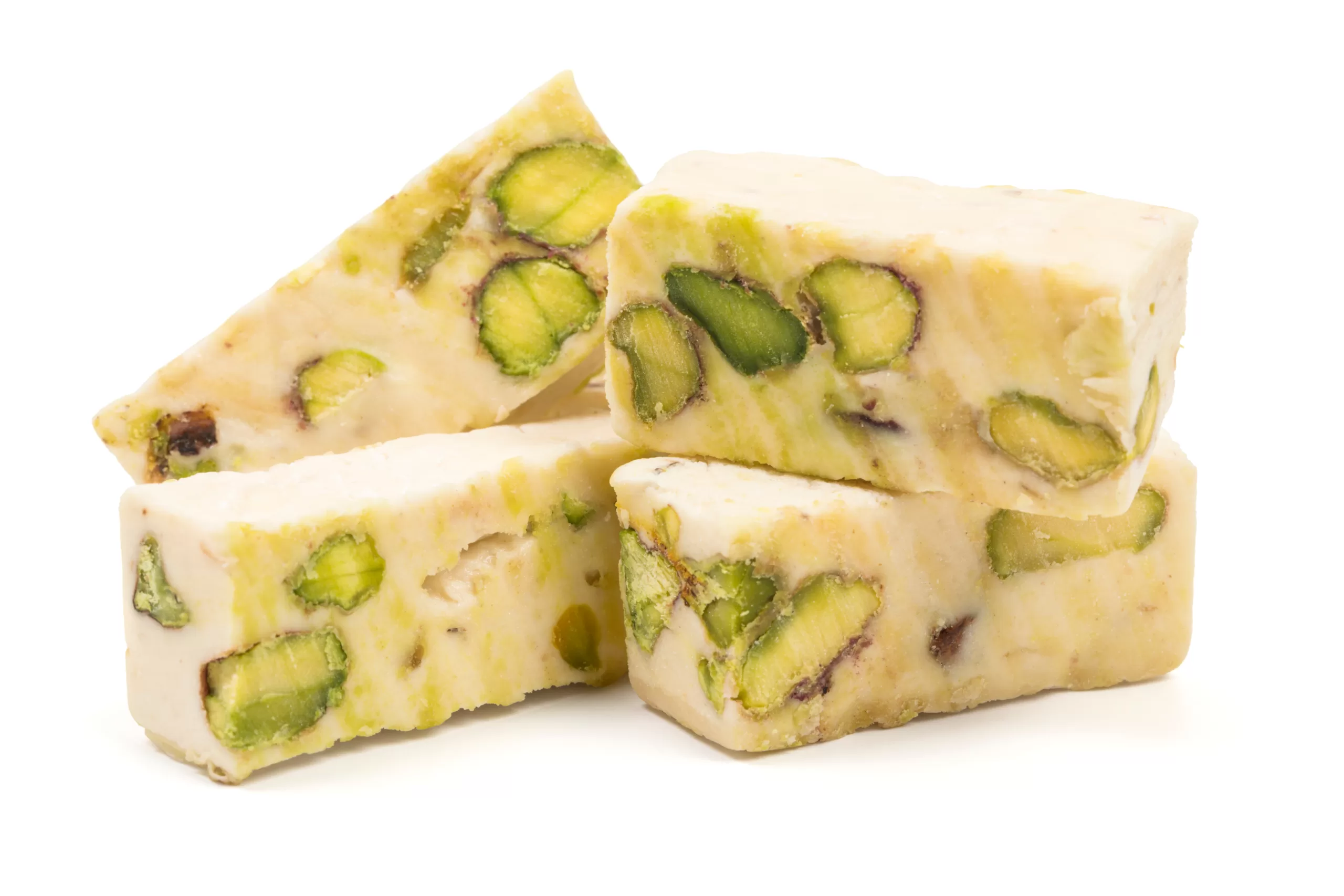 A few cubes of pistacchio torrone stacked over each other. 