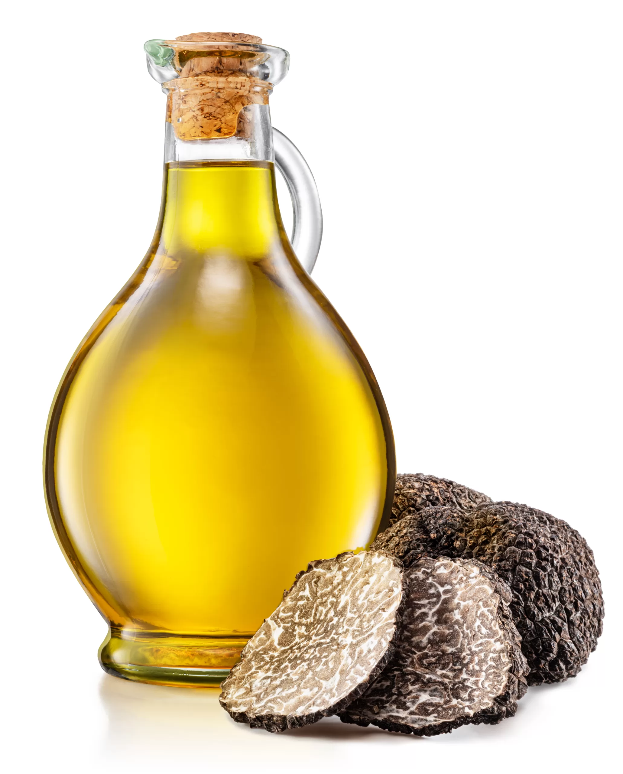 A bottle of truffle oil and a few fresh truffles on a white background. 