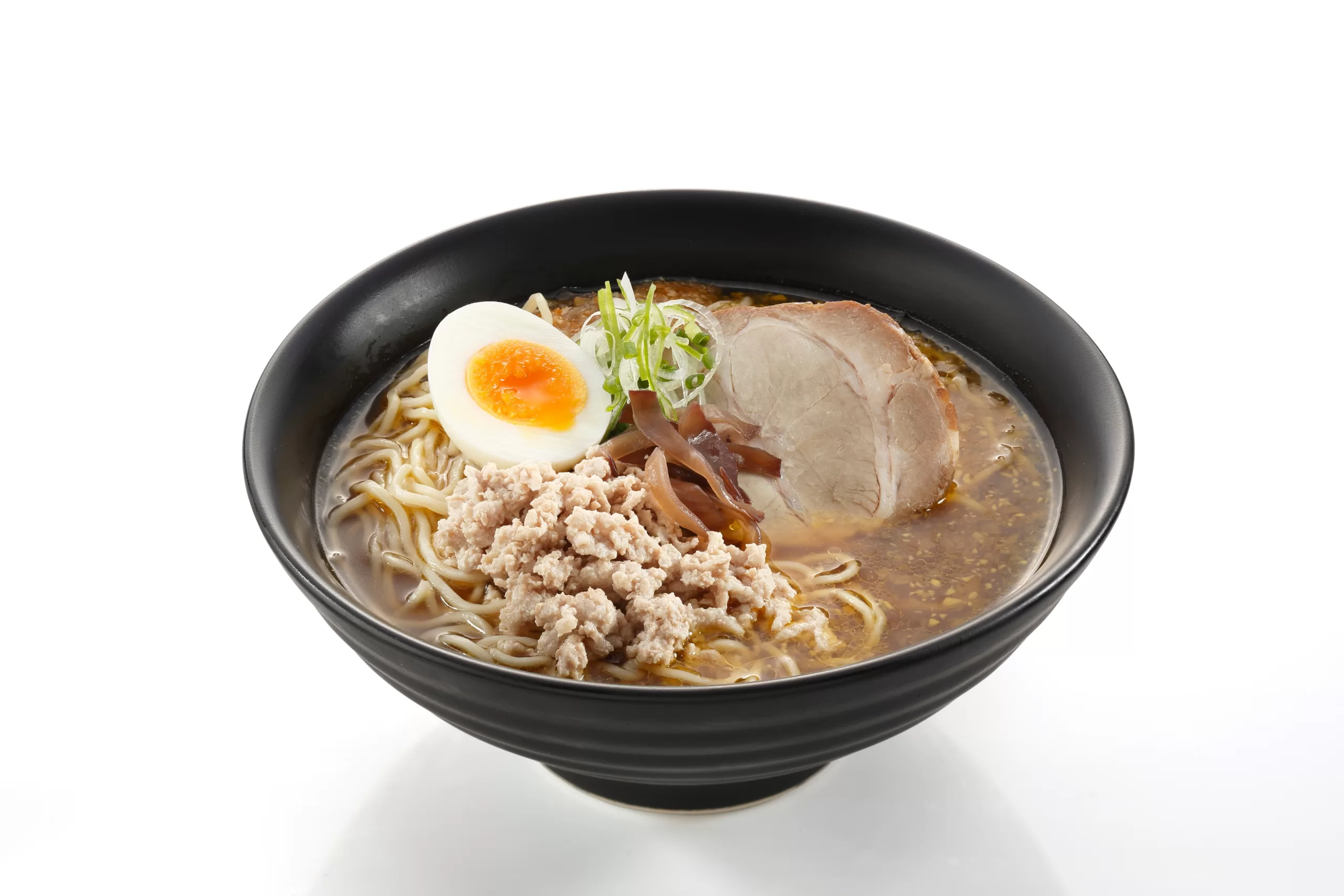 An isolted serving of tonkotsu ramen against a white backdrop. 