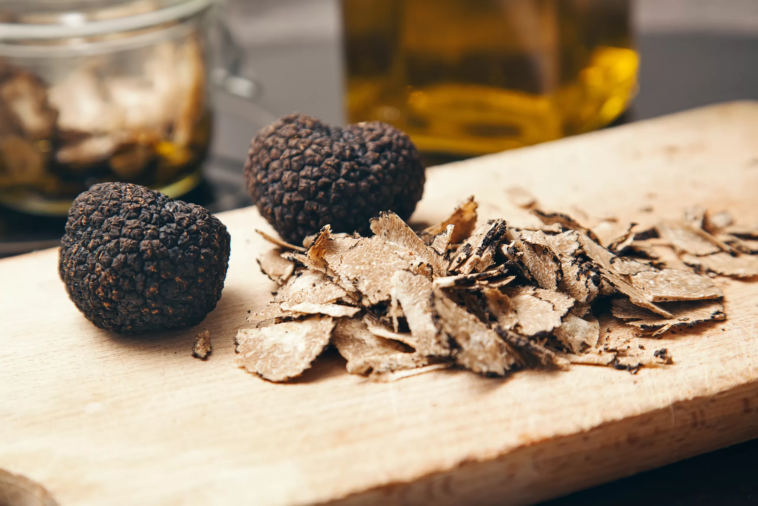 Entire and chopped truffles on a chopping board. 