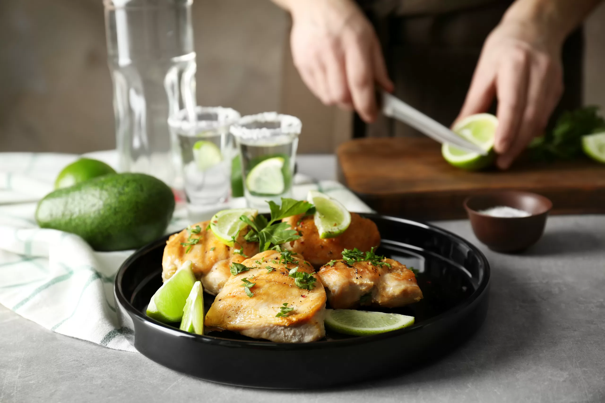 Preparing tequila lime chicken on a concrete countertop. 