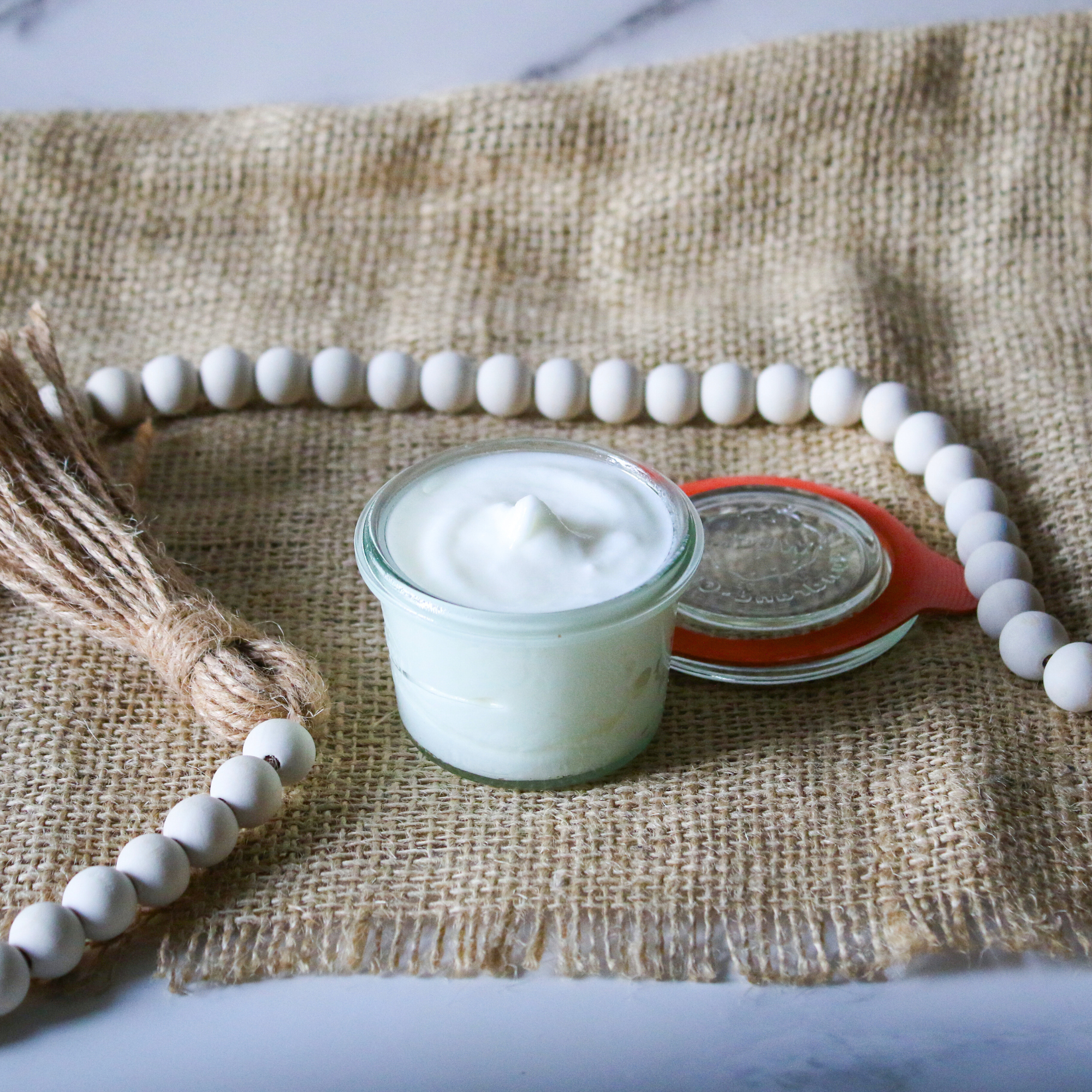 Whipped shea butter in a glass jar.