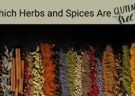 A black surface showcasing an arrangement of different herbs and spices. The text reads, "Which Herbs and Spices Are Gluten-Free?"