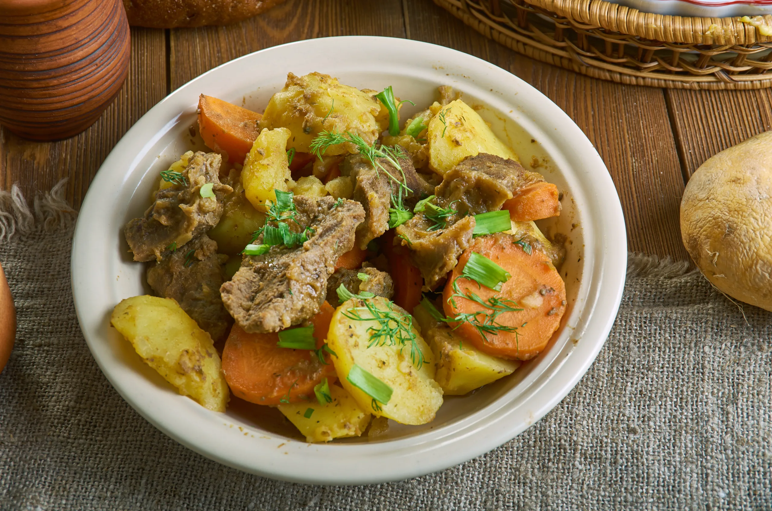 A wooden table displaying a portion of homemade zharkoe.