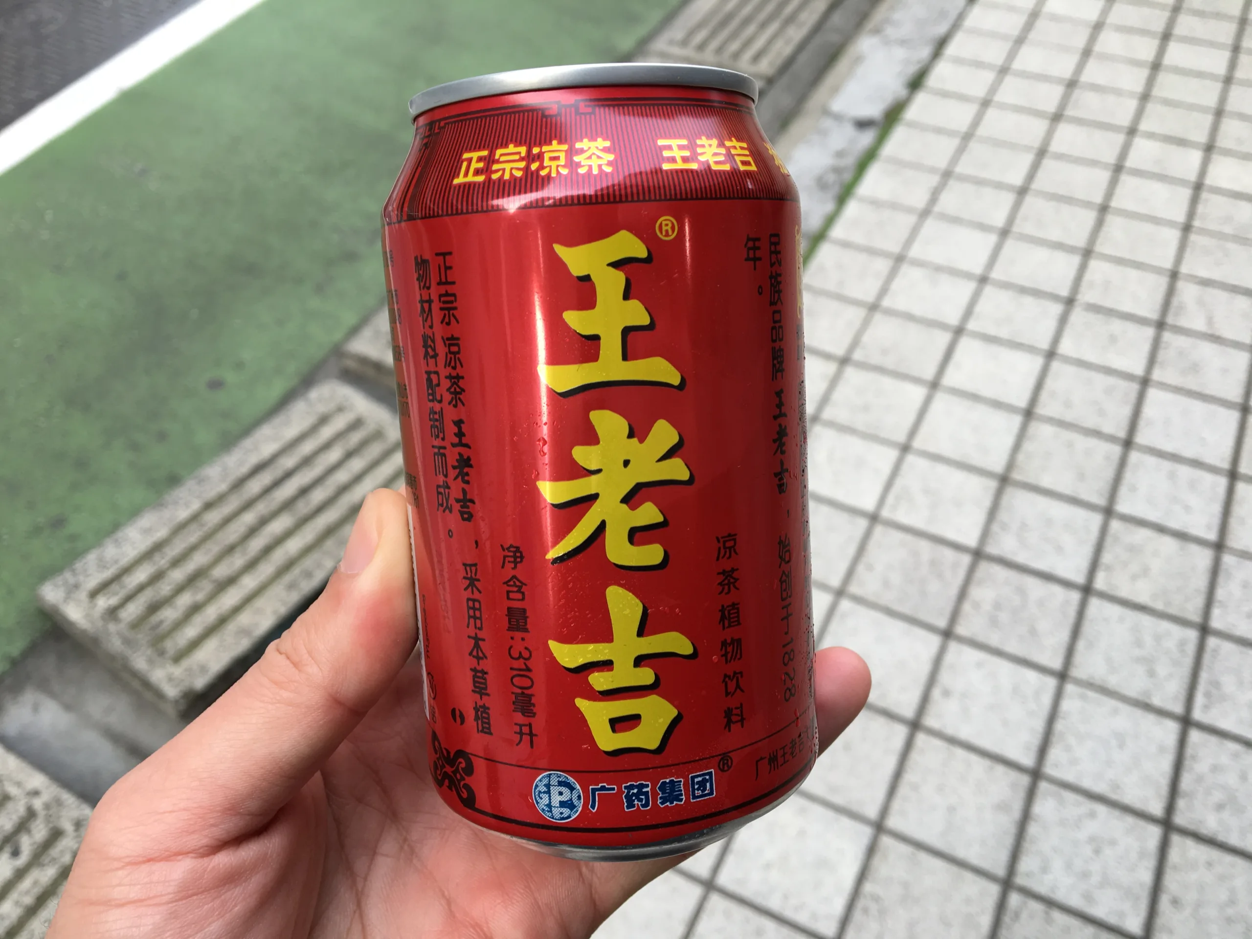 A man holding a can of Wong Lo Kat.