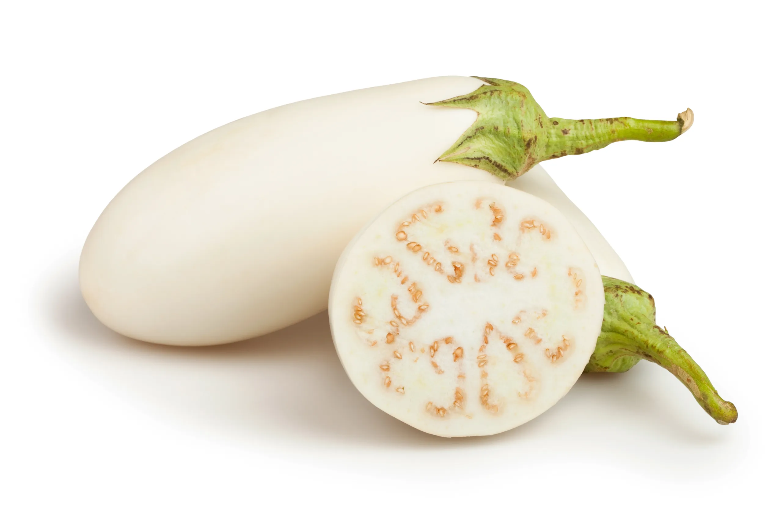 A few white eggplants against a plain backdrop.