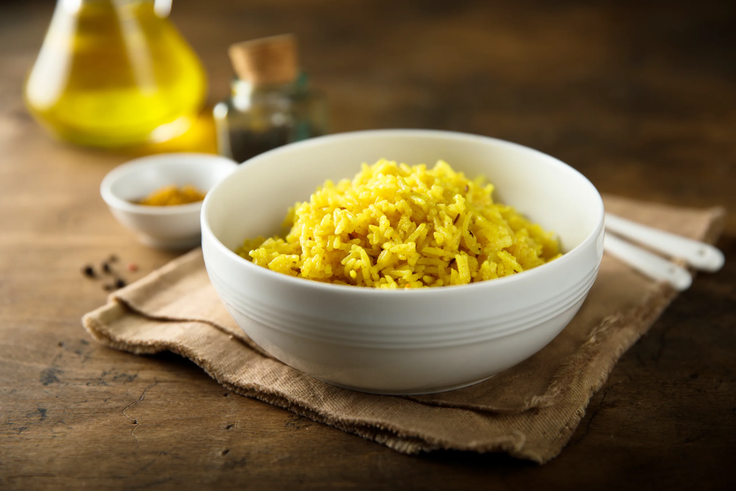 A zhoug rice bowl placed on a wooden table. 