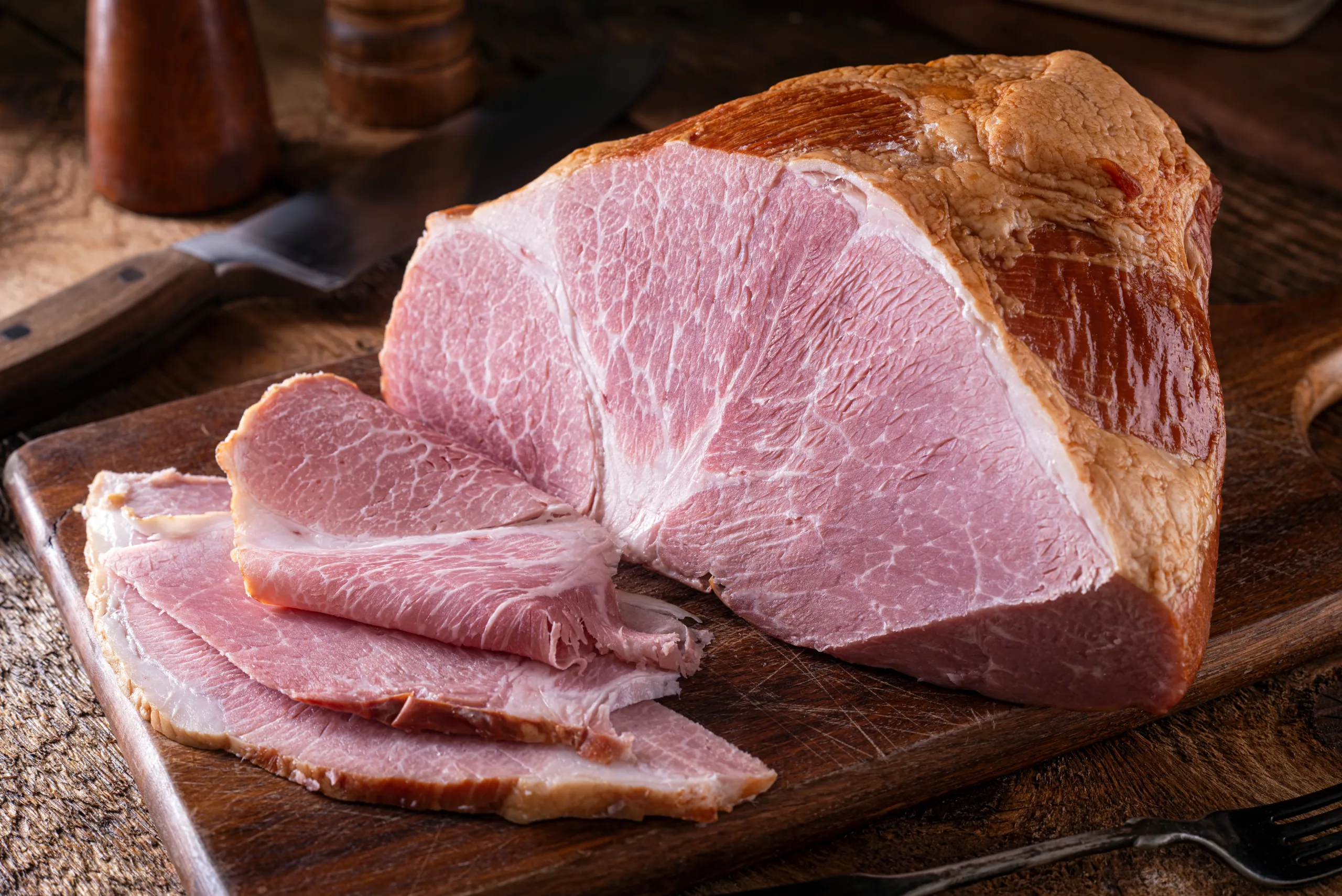 A tasting Westphalian ham partially sliced.