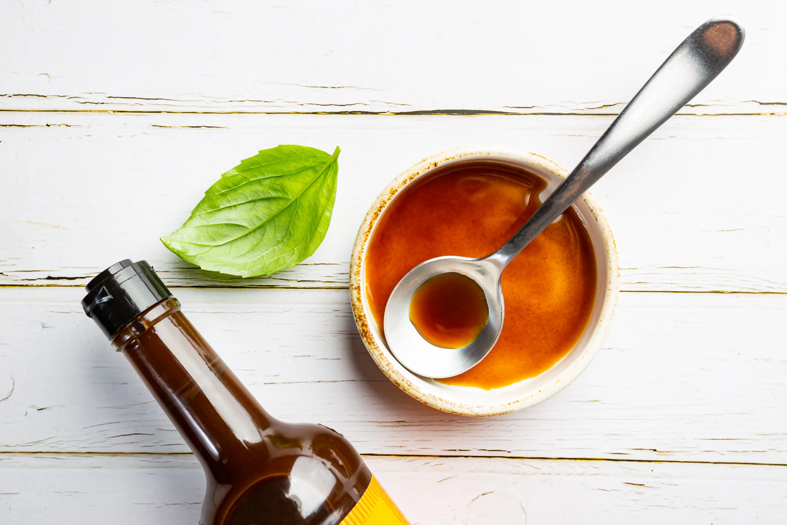 Worcestershire sauce on a white vintage table.