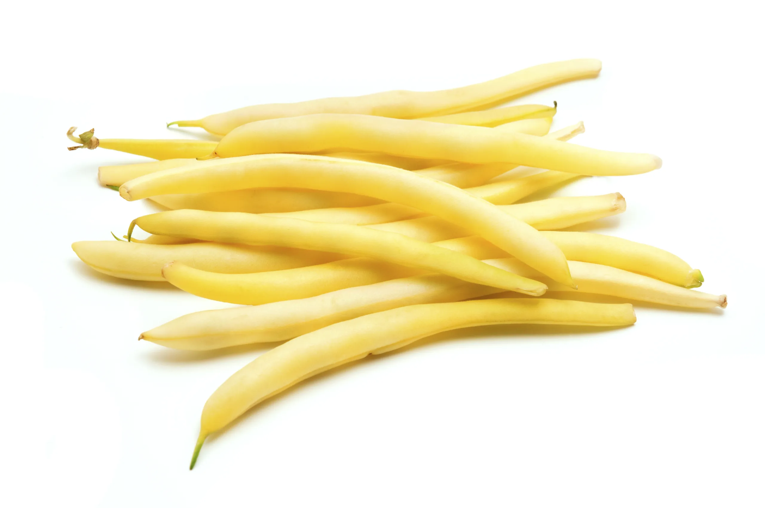An isolated heap of wax bean pods on a white background.