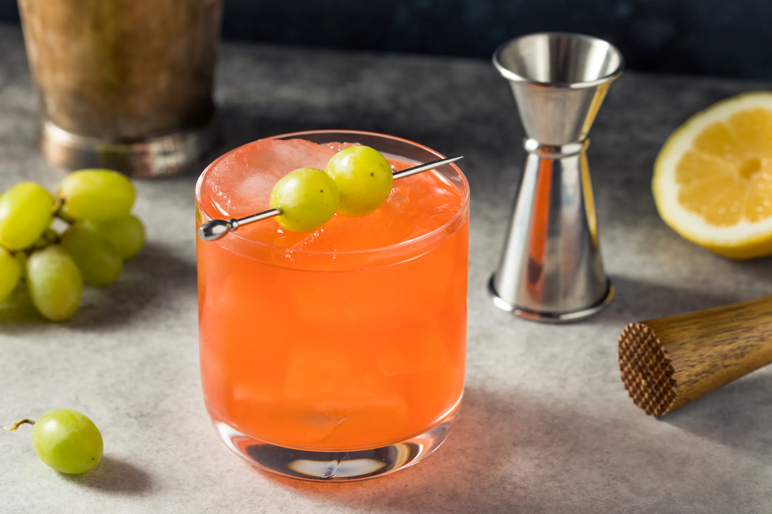 A glass of refreshing zima blaster beverage on a concrete table. 