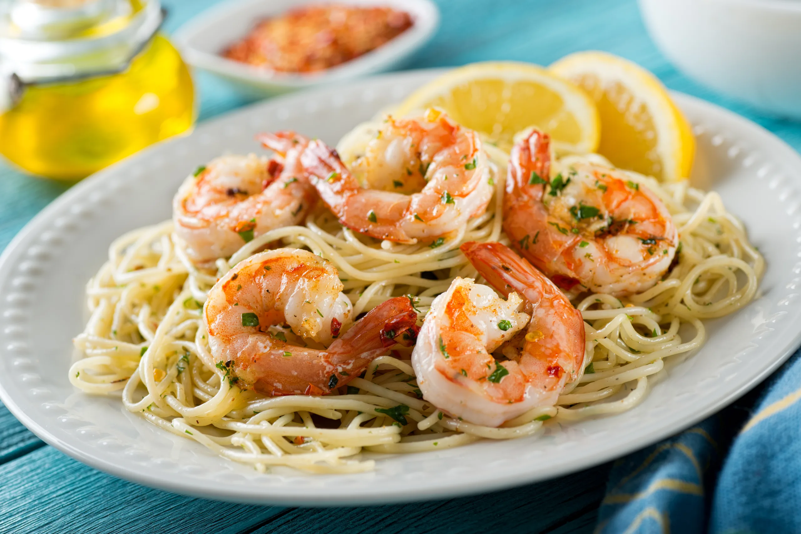 A close-up of a serving of zesty garlic shrimp pasta.