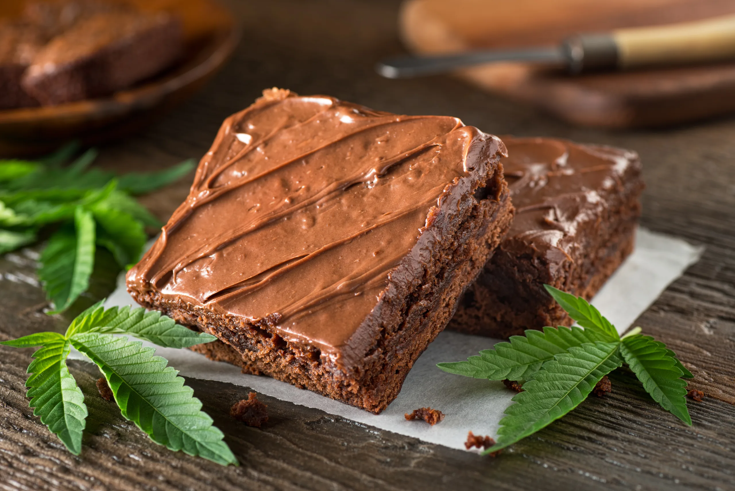 Delicious homemade weed brownies on a wooden table.
