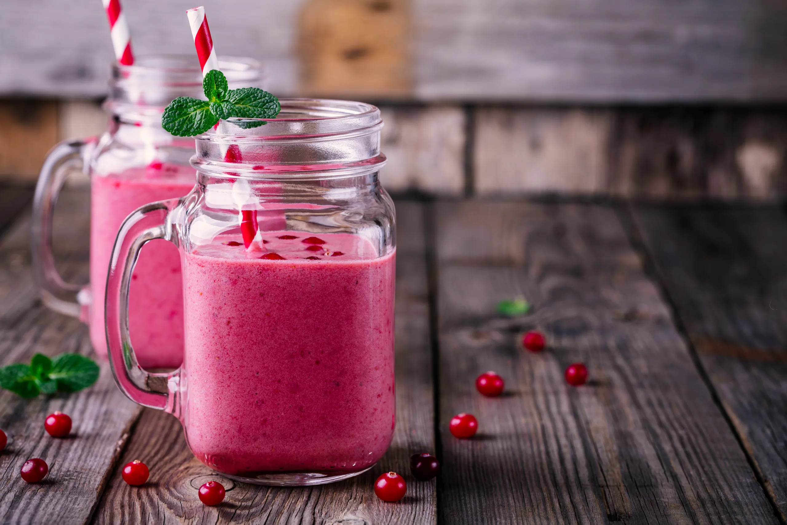 A couple of mugs filled with wildberry smoothie.