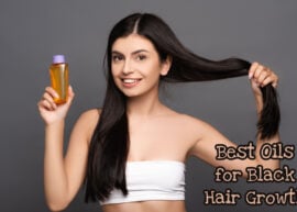 A woman with long black hair showing a hair oil bottle. The text reads, "Best Oils For Black Hair Growth."
