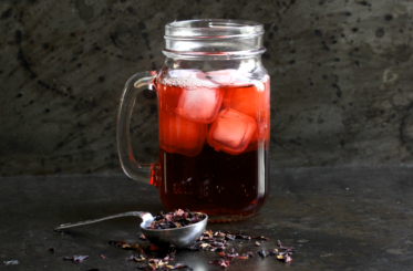 Iced Hibiscus Honey Tea with Apple Cider Vinegar in a mug with ice