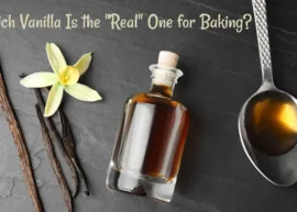 Vanilla sticks, flower, and essence resting on a dark surface. The text reads, "Which Vanilla Is the "Real" One for Baking?"
