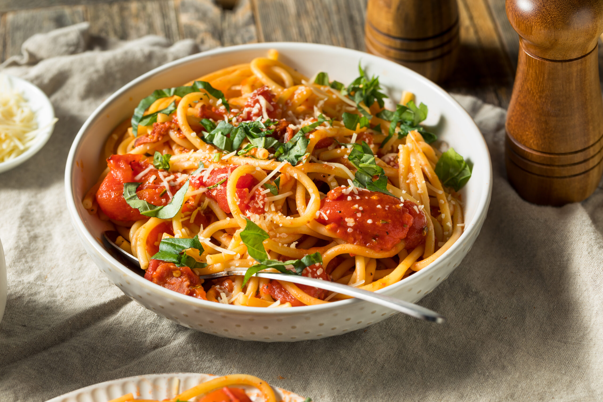 Homemade bucatini all Amatriciana with tomato and basil.