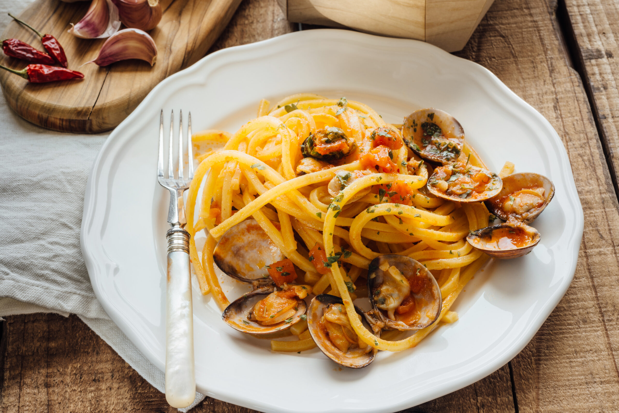 Fresh bigoli with seafood in tomato sauce.