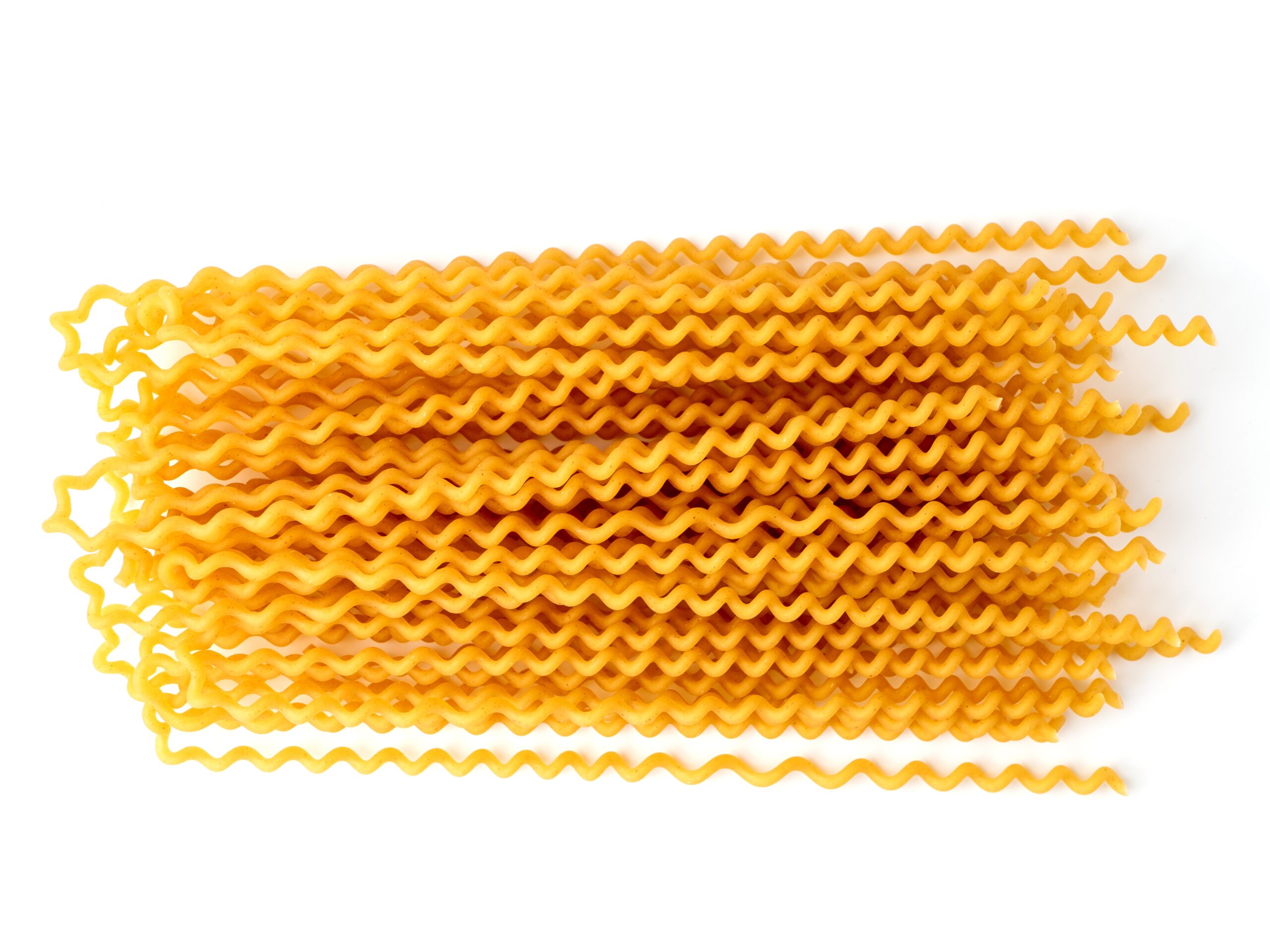 Raw canule pasta isolated on a white background. 