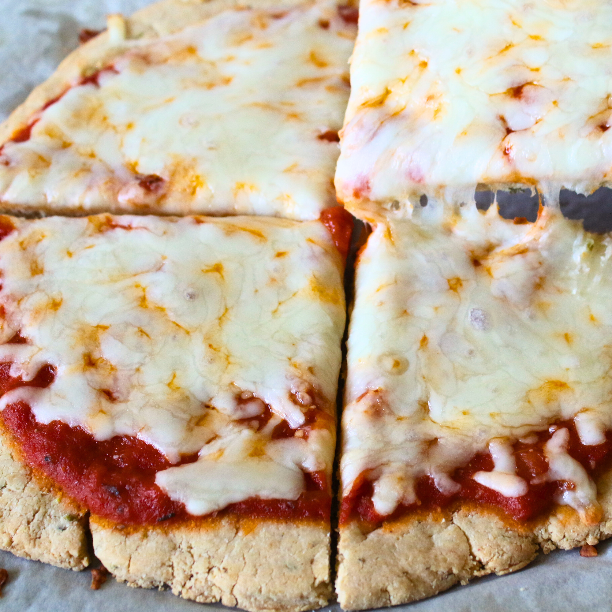 A cheese pizza cut into four pieces. 