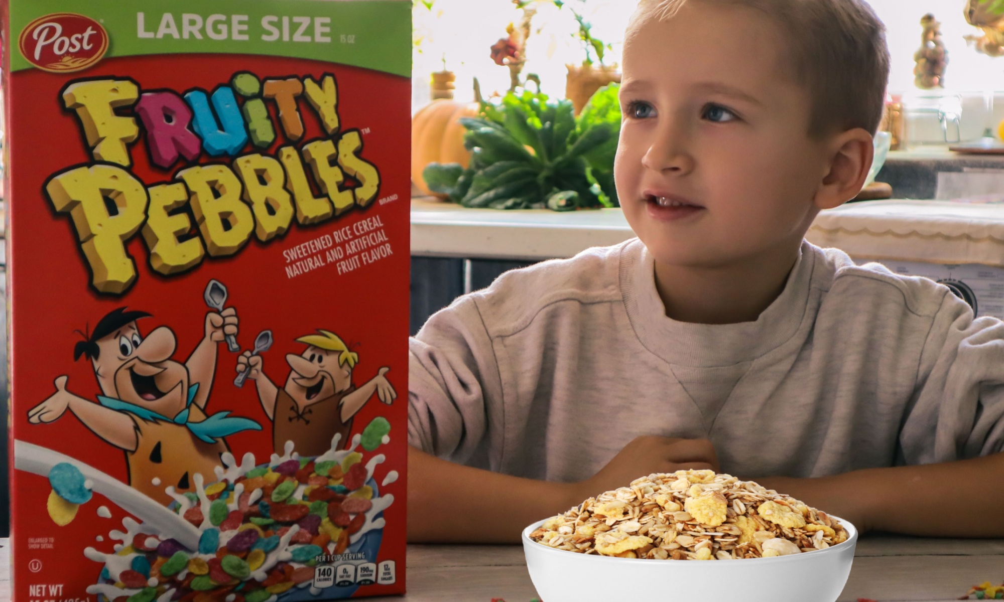 A cute boy ready to enjoy a rainbow granola breakfast. 