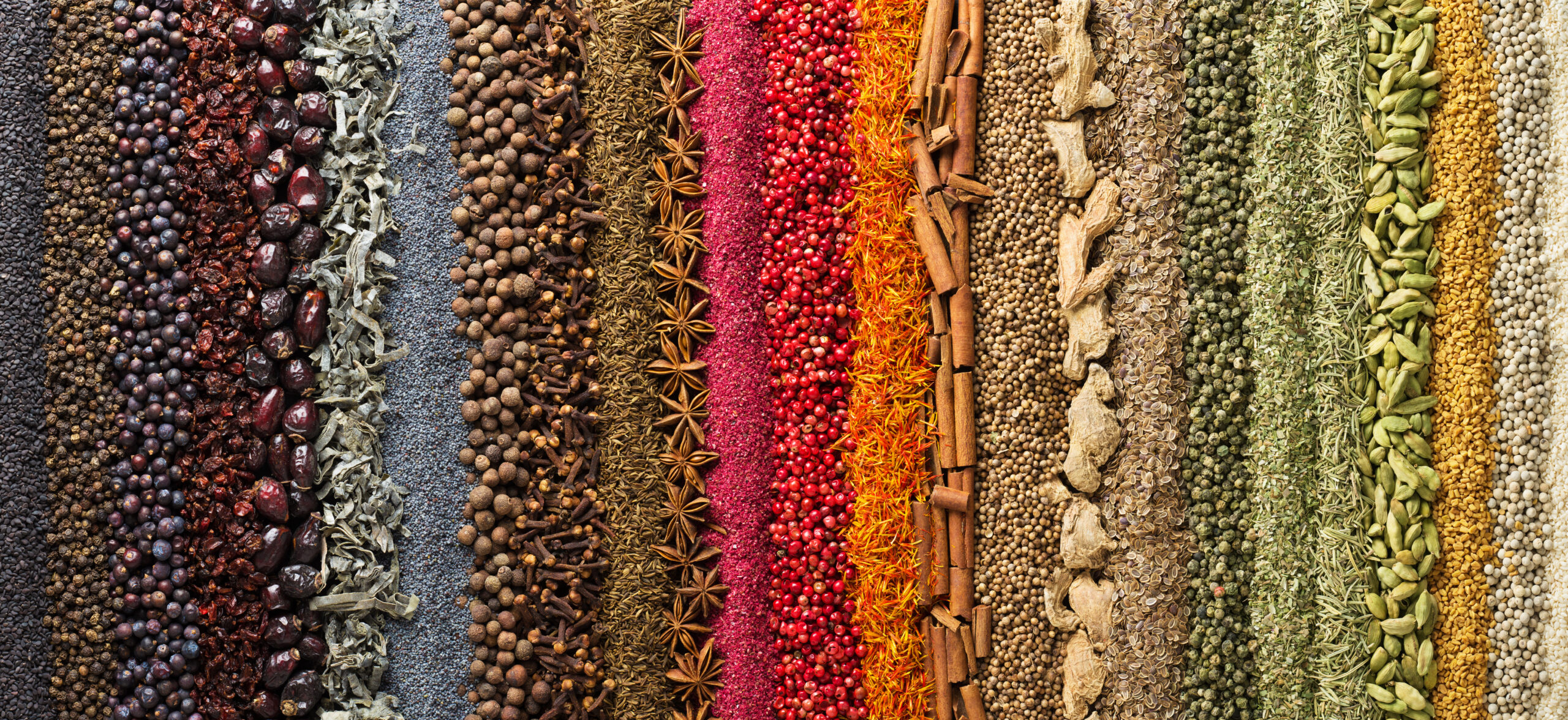A rainbow arrangement of spices and herbs, which can be picked to prepare raibow seasoning.