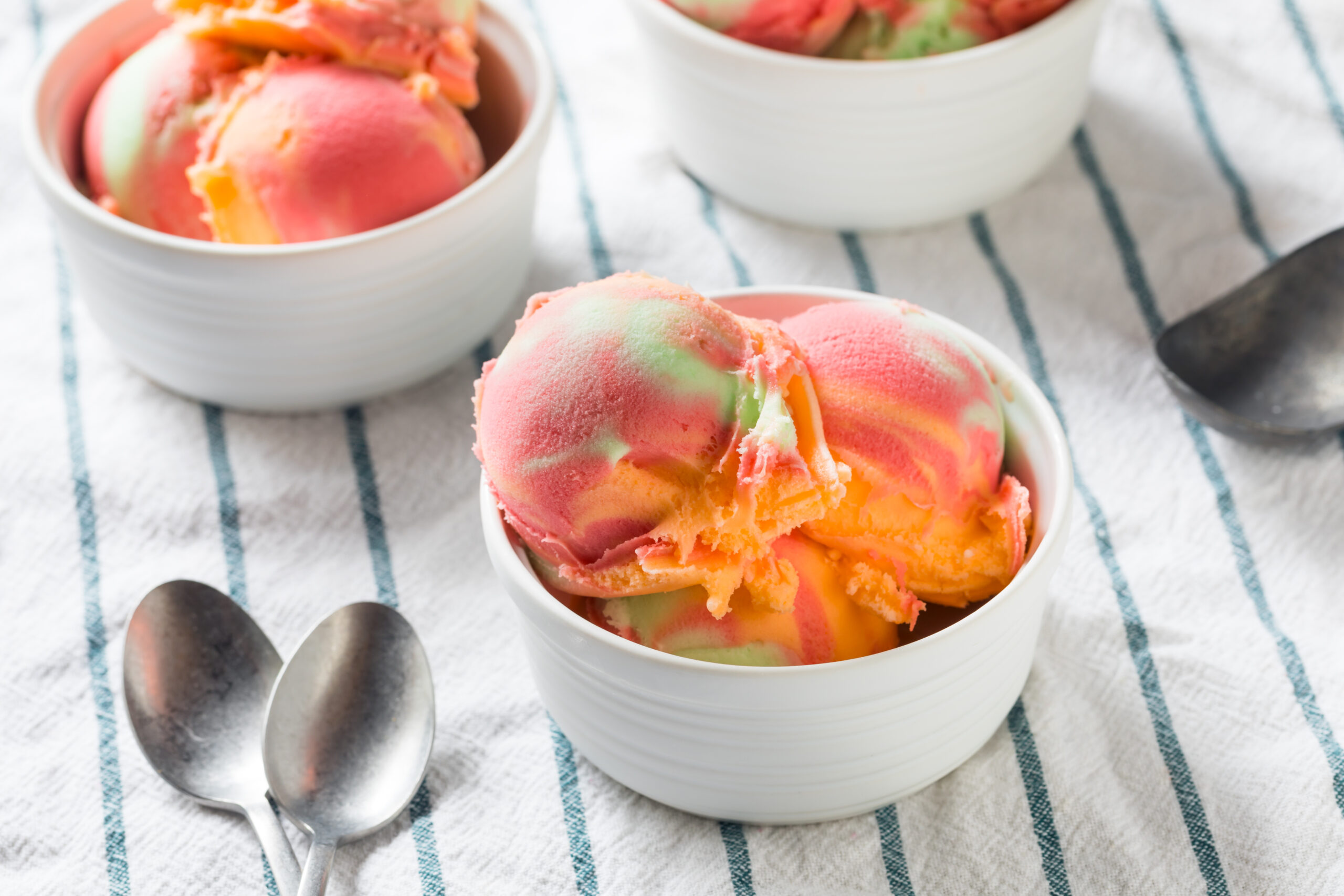 Three portions of homemade rainbow sorbet. 