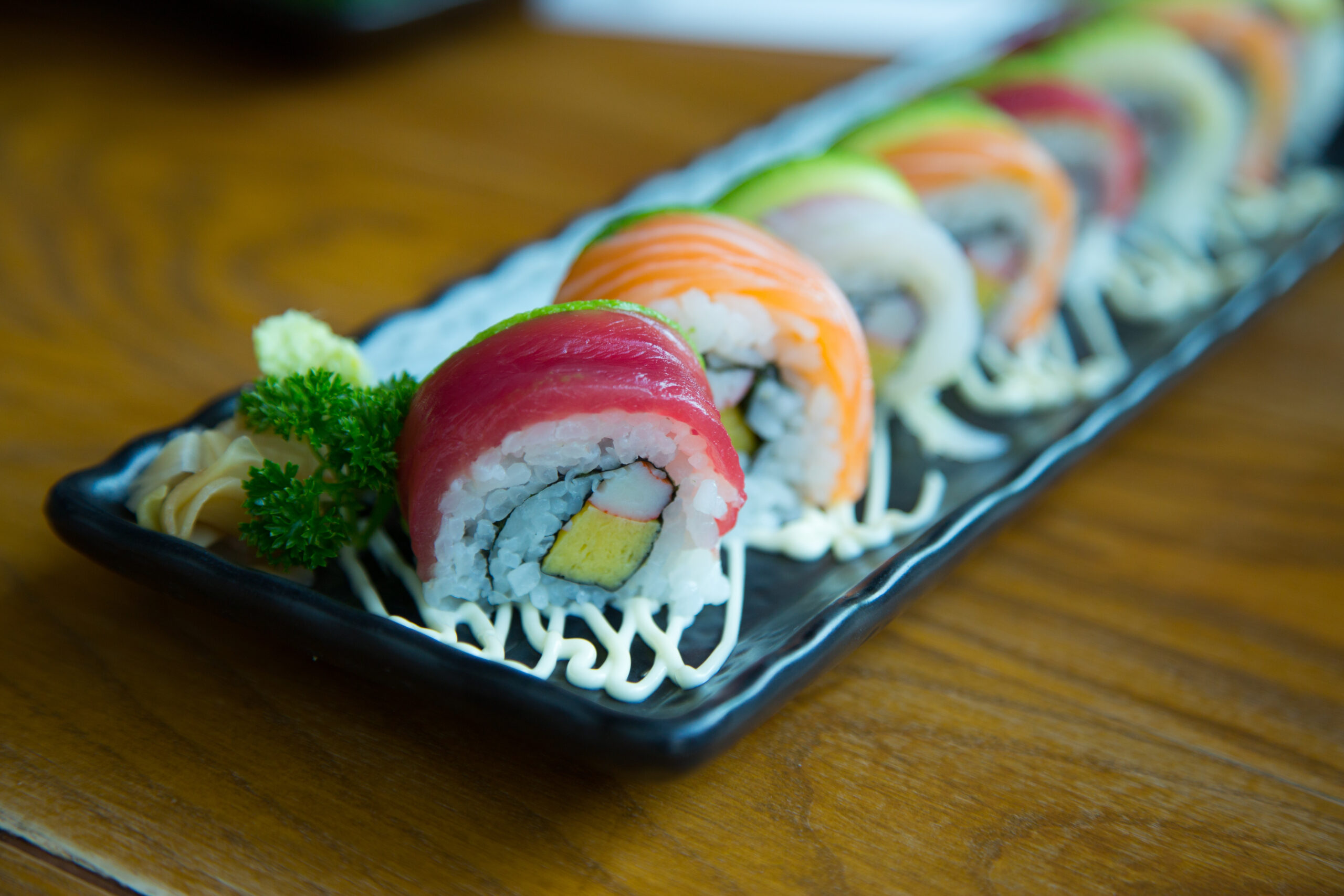A tray featuring rainbow sushi pieces. 