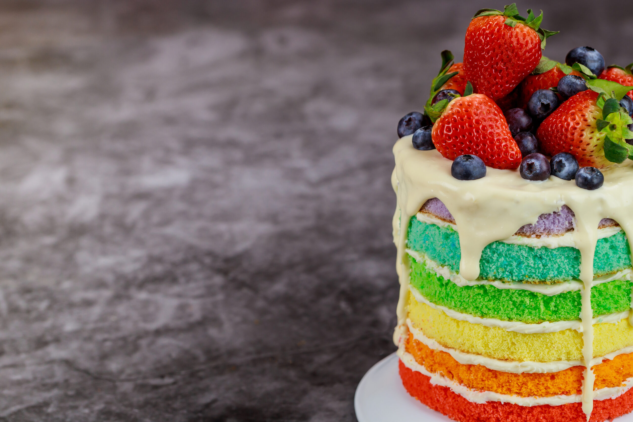 Close-up view of a rainbow birthday cake. 