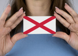Woman holding an Alabama flag