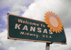 Road sign reads "Welcome to Kansas Midway, U.S.A."