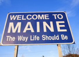 Blue road sign reading "Welcome to Maine The Way Life Should Be"